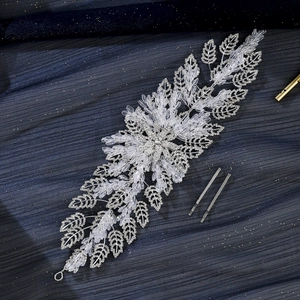Macro detail of handmade bridal headband with silver crystal beads and floral leaf design