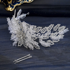 Luxury silver bridal headband with sparkling crystals and rhinestones on blue fabric