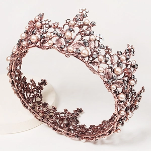 Baroque rose gold bridal crown with white pearls and grey rhinestones on pedestal