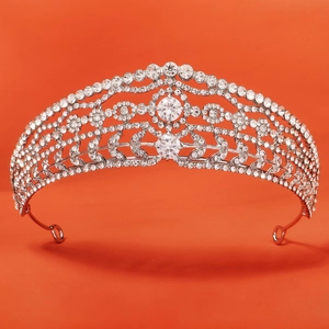 Macro shot of silver wedding crown showing intricate hollow metalwork and sparkling rhinestones