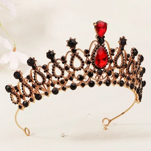 Detailed macro view of vintage gold alloy bridal crown with black rhinestones and red rubies