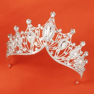 Close-up of silver crown with marquise-cut rhinestones on bright orange backdrop