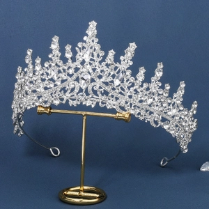 Detailed close-up of a silver alloy bridal tiara featuring sparkling crystal teardrops
