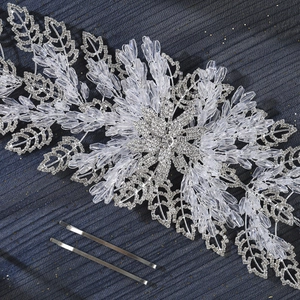 Luxurious bridal headband with crystal beads and silver leaf motifs on blue background
