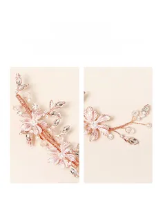 Detail of luxury bridal hair clip with pink metal flowers, pearls and crystals
