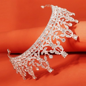 Close-up of a silver baroque crown with sparkling rhinestones and teardrop crystals