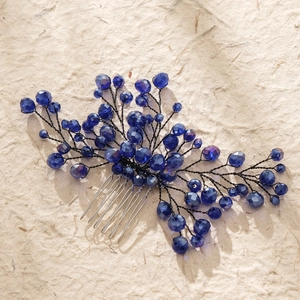 Macro detail of handmade blue bead branch hair comb with intricate wire wrapping