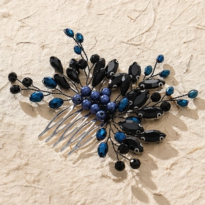 Close-up of bridal hair comb featuring blue beaded floral accents and silver teeth