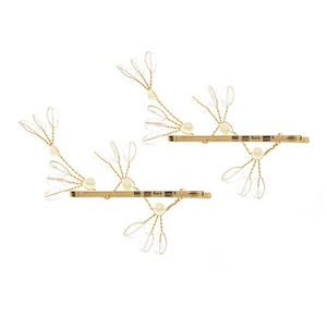 Détail de barrettes dorées en forme de branche avec cristaux et petites perles