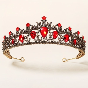 Detail of vintage bronze alloy bridal crown with red pear-shaped rhinestones and dark crystals