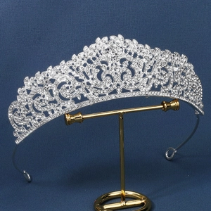 Intricate detail of silver baroque crown with shimmering rhinestones on T-stand display