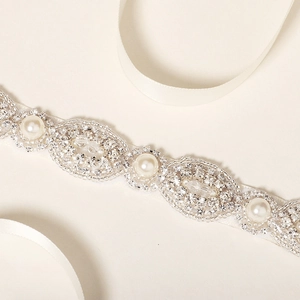 Elegant bridal belt with pearls and rhinestones on ivory satin for wedding dresses