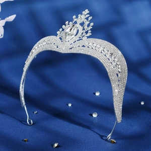 Detailed close-up of luxury bridal tiara with sparkling crystal patterns on silk