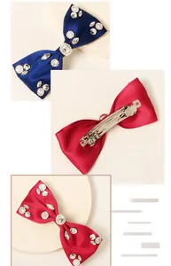 Detail of satin bow hairclip with rhinestones and silver metal spring clip structure