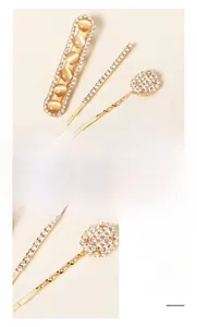 Détail d'un ensemble de barrettes coréennes avec strass et pierres œil-de-chat dorées