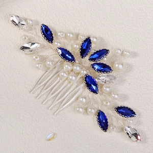 Detail view of bridal hair comb with blue crystal leaves and pearls on silver wire
