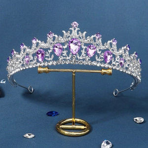 Vintage silver bridal crown with purple teardrop crystals on a dark blue background