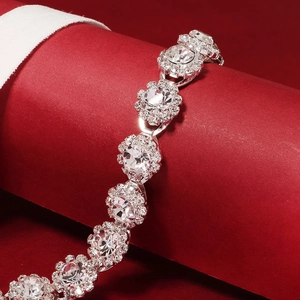 Elegant bridal garter with flower rhinestone clusters on red festive background