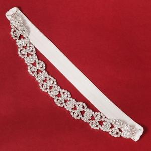 Detail of bridal elastic garter with silver vine pattern rhinestones on red background