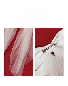 Detail of white bridal bow hair clip with crystals, rhinestones and mesh on red velvet