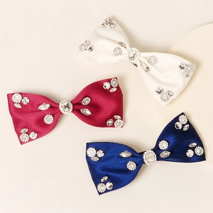 Three-piece set of satin bow hair clips with rhinestones in cream, burgundy, and navy