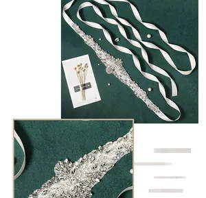 Detailed view of hand-sewn floral crystal applique on a white bridal wedding dress sash