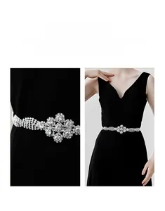 Close-up of luxury bridal belt with sparkling rhinestones on black dress detail
