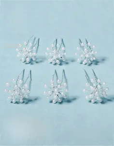 Detail of 6-piece bridal U-shaped hair pins with handmade pearls and silver wire craftsmanship