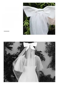 Detailed view of white satin bow hairclip with layered bridal tulle veil and spring clip
