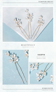 Détail d'épingle à cheveux fleur blanche en acrylique avec tiges dorées et finitions tissées
