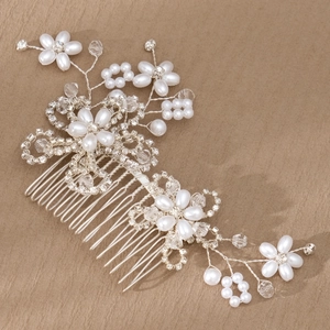 Macro shot of bridal hair comb with pearls, crystals and silver alloy weave