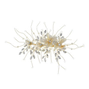 Detailed shot of handmade gold wire hair comb with cream flowers and crystal leaves