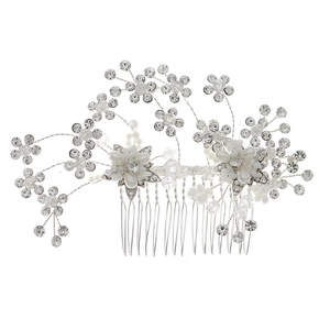 Handmade bridal hair comb with silver crystal flowers and pearls on white background