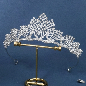 Elegant silver bridal tiara with sparkling rhinestones on a metal display stand