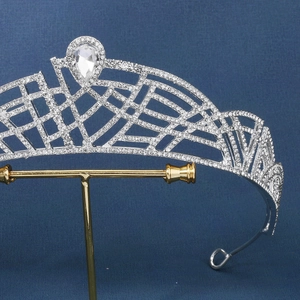Macro detail of silver alloy bridal crown featuring sparkling rhinestones and a pear-cut gem