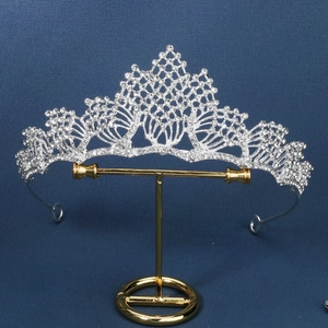Elegant silver princess tiara with crystal rhinestones on a metal display stand
