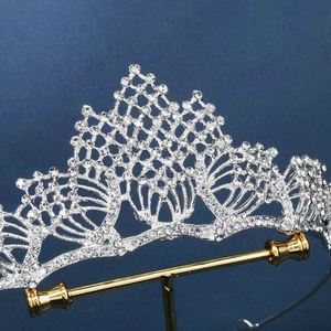 Elegant bridal alloy tiara with sparkling white rhinestones on a dark blue background