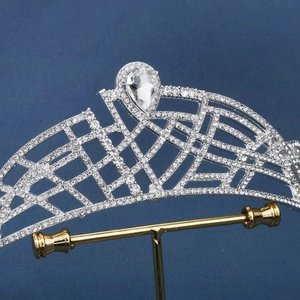 Silver bridal crown with intricate hollow lattice design and large teardrop rhinestone