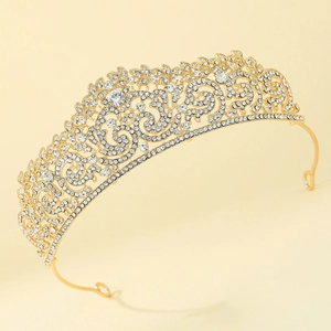 Macro detail of vintage gold bridal crown featuring intricate scroll patterns and crystals