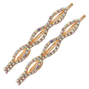 Barrettes à cheveux dorées avec strass AB scintillants sur fond blanc épuré