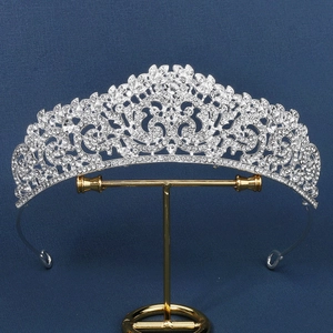 Silver vintage bridal crown with intricate hollow patterns and sparkling rhinestones
