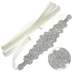 Luxurious bridal sash featuring intricate crystal rhinestone patterns on white satin ribbon