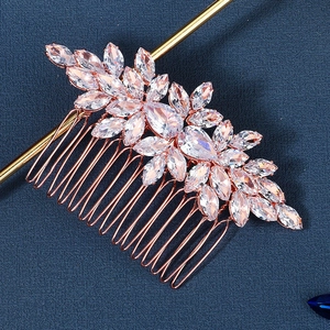 Macro detail of rose gold bridal hair comb with marquise and pear cut cubic zirconia stones