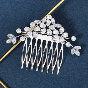 Detailed close-up of a silver bridal hair comb with shimmering leaf-shaped cubic zirconia