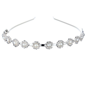 Detalle de la diadema de flores de circonitas y perlas sobre un marco de metal plateado