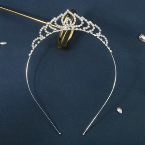Silver alloy teardrop headband with sparkling rhinestones on a navy blue background
