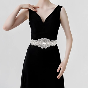 Exquisite handmade bridal belt with sparkling rhinestones on a black evening gown