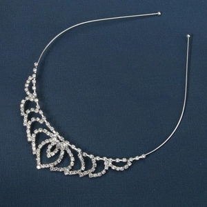 Detailed view of silver hairband featuring sparkling pavé crystals and heart patterns