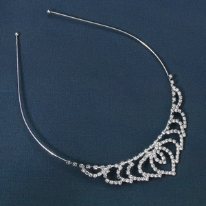 Elegant silver tiara headband with teardrop rhinestones and heart motif on blue fabric