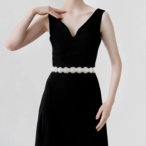 Detailed view of luxury bridal belt with pearls and rhinestones on a black dress